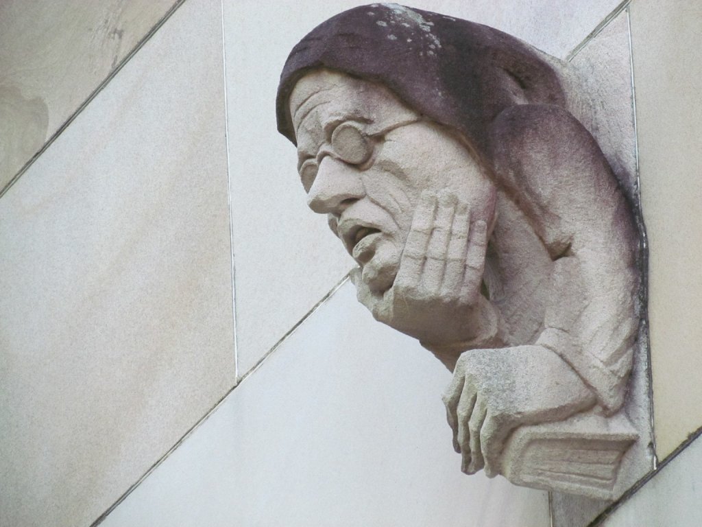 A close view of one of the heads on the wall